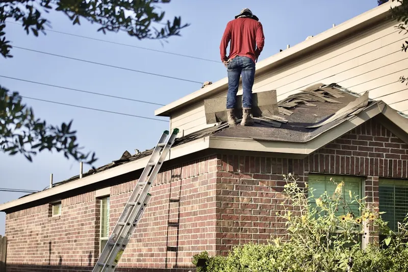 Professional roofer working on a residential roof in Kingtown